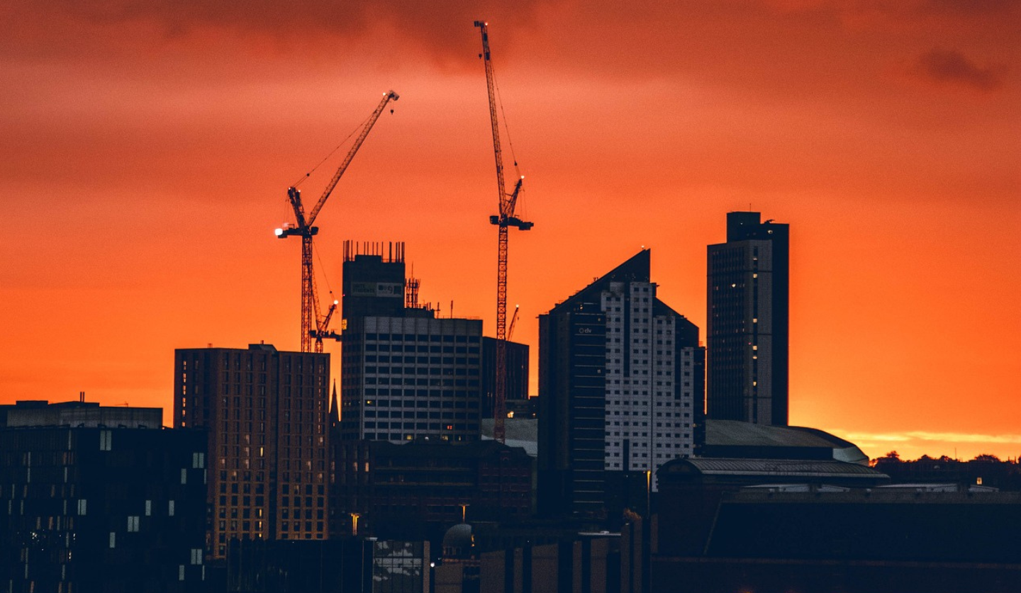 Skyline with cranes and apartment buildings.